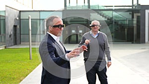 Senior and mature businessmen using the VR headset with actions