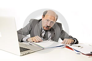 Senior mature busy business man with bald head on his 60s working stressed and frustrated at office computer laptop desk