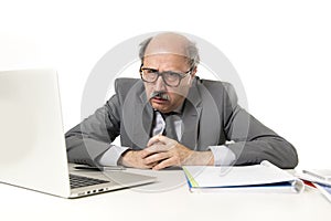 Senior mature busy business man with bald head on his 60s working stressed and frustrated at office computer laptop desk looking a