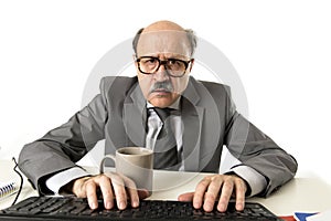 Senior mature busy business man with bald head on his 60s working stressed and frustrated at office computer laptop desk looking a