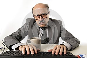 Senior mature busy business man with bald head on his 60s working stressed and frustrated at office computer laptop desk looking a