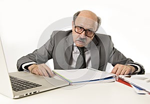 Senior mature busy business man with bald head on his 60s working stressed and frustrated at office computer laptop desk