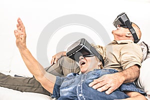 Senior mature couple having fun together with virtual reality he