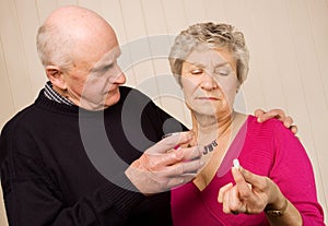 Senior mature couple taking pain medication