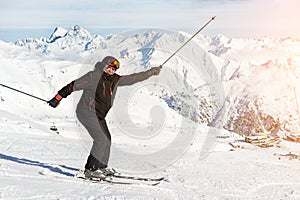 Senior mature happy funny skier having fun and fooling around at winter alpine skiing resort. Old aged sporty person