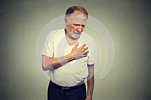 Senior mature man suffering from bad pain in his chest heart attack