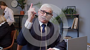 Senior mature old business man pointing to camera, choosing lucky one winner, meaning we need you
