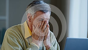Senior mature older businessman looking laptop nervous work stress problems losing failure at home office elderly man