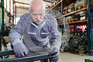 Senior mechanic working in factory