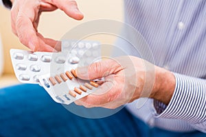 Senior medicate with pills at home