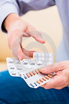 Senior medicate with pills at home