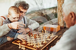 Senior men having fun and playing chess