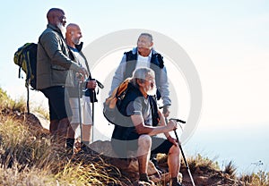 Senior, men and hiking in nature, relax and calm, sitting and happy on blue sky background. Elderly, friends and man