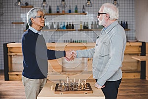 Senior men playing chess