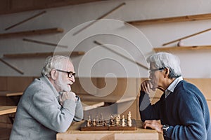 Senior men playing chess