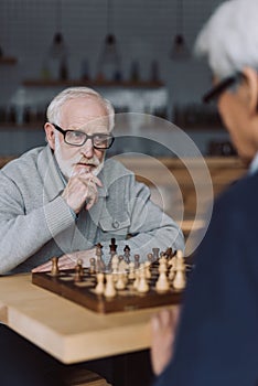 Senior men playing chess