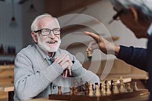 Senior men playing chess