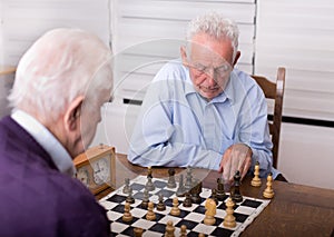 Senior men playing chess