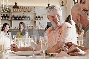 Senior Men Socialising At A Dinner Party