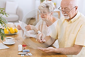 Senior man taking medication photo
