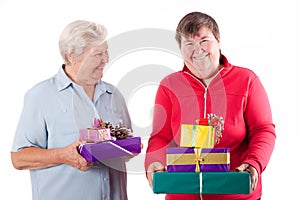 Senior and mental disabled woman holding gift