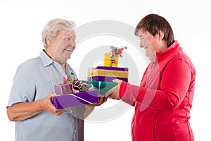 Senior and mental disabled woman holding gifts