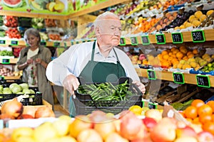 Senior merchandiser working in greengrocer