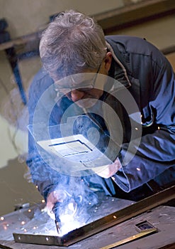 Senior metalworker welding