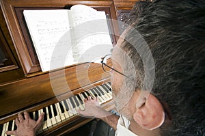 Senior middle age man playing piano