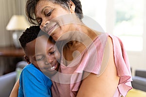 Senior mixed race woman and her grandson enjoying their time at home