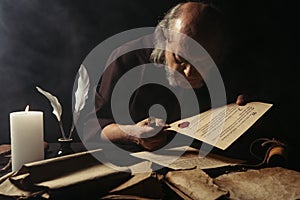 senior monk looking at chronicle stamped