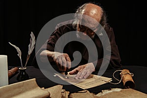 senior monk stamping manuscript with wax