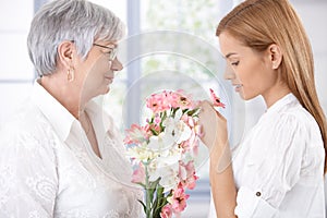 Senior mother and daughter with flowers