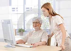 Senior mother and daughter using computer