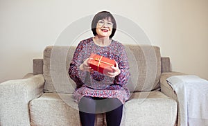 Senior mother receives a present at home