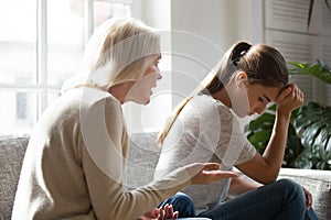 Senior mother talk scolding annoyed adult daughter at home