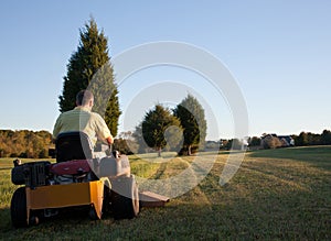 Senior mowing lawn