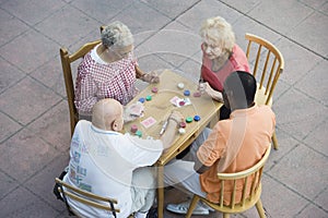 Senior Multiethnic Friends Playing Cards Together