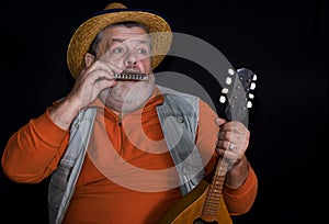 Senior musician playing mouth-organ