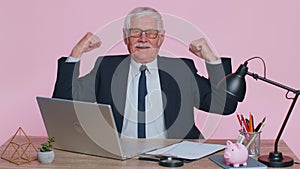 Senior office businessman showing biceps, looking confident, feeling power strength to success win