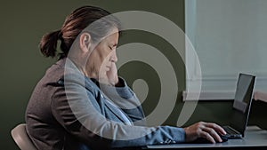 Senior office worker in formal blazer working late in firm