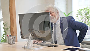 Senior Old Businessman having Back Pain while Working on Computer