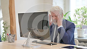 Senior Old Businessman having Headache while Working on Computer