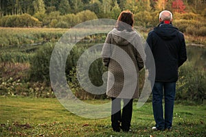 Senior old couple walking in the park forest lifestyle love sport watching sunset