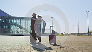 Senior old husband and wife retirees tourists reunion meeting in airport terminal after traveling