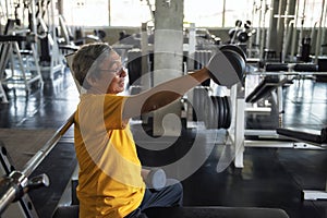 Senior old man dumbbell exercise in gym