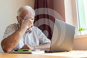 Senior old man male sit desk, home office online notebook laptop work distance freelancer tired unhappy sad sleeping
