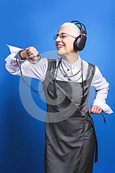 Senior business woman dancing to the beat of the music