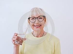 Senior old woman in senior woman holding glass of water and drinking water.