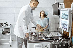 Senior otolaryngologist with female patient in the ENT office